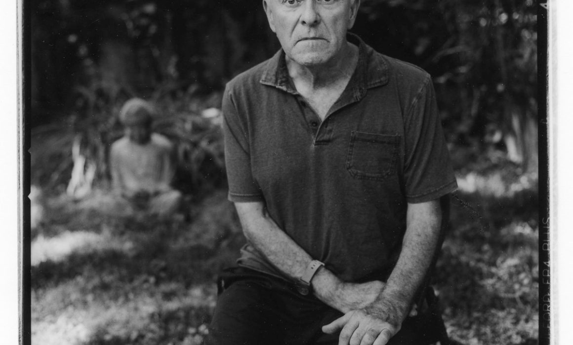 Louis Bickett in his Backyard Sitting Near Budda by Guy Mendes