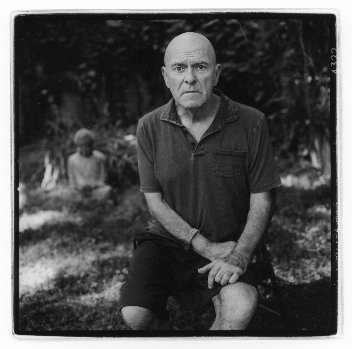 Louis Bickett in his Backyard Sitting Near Budda by Guy Mendes
